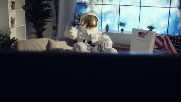 Astronaut Relaxing Apartment Watching Drinking Beer — Stock Video