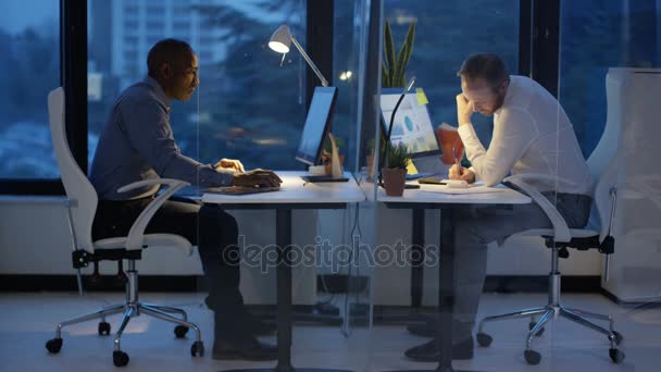 Businessmen Working Late Looking Financial Data Computer Screens — Stock Video