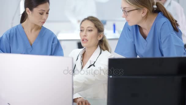 Female Medical Team Modern Hospital Looking Computers Having Meeting — Stock Video