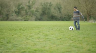 4 k mutlu genç Asyalı baba ve açık havada futbol oynayan ve having fun