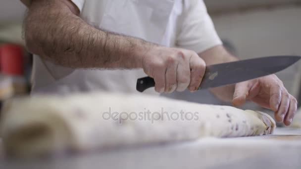 Close Hands Man Cutting Roll Fruit Tough Bakery Shop Kitchen — стоковое видео