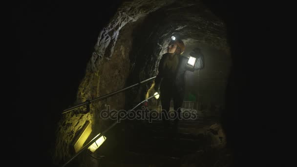 Team Potholers Hard Hats Lamps Exploring Underground Cave System — Stock Video