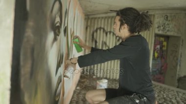 4k görüntü portre surların üzerine kopyalamak için telefonu kullanarak maskeli grafiti sanatçısı
