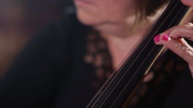 4K Close up on hands of orchestra cellist during a performance
