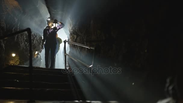 Potholers Exploring Cave System Shafts Light Penetrating Dark — Stock Video
