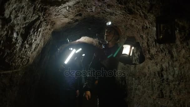 Team Potholers Hard Hats Lamps Exploring Underground Cave System — Stock Video