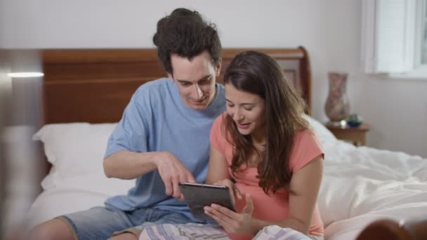 Portrait Smiling Couple Expecting Baby Bedroom Computer Tablet — Stock Video