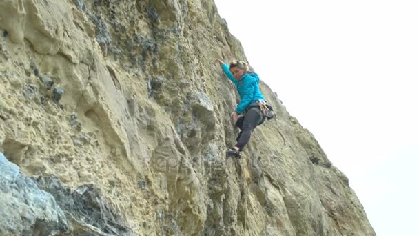 Молодая Женщина Лазает Вертикальной Скале Лицо Пытаясь Найти Сильный Захват — стоковое видео