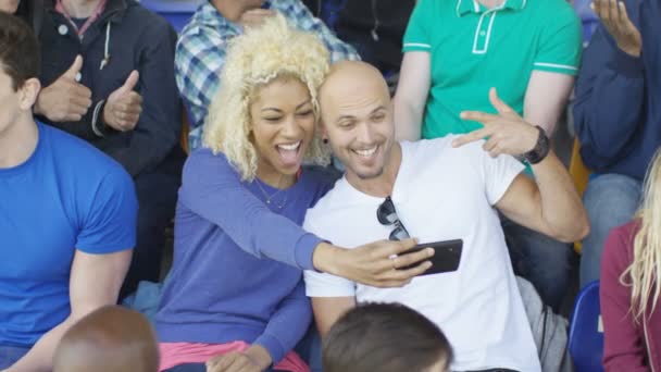 Paret Sitter Publiken Sport Event Poserar Att Selfie Med Telefon — Stockvideo