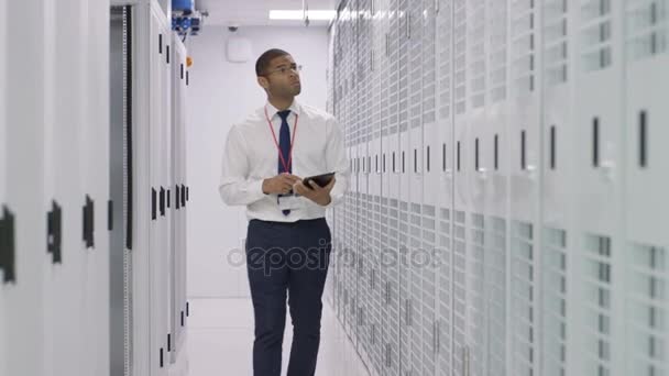 Engineer Computer Tablet Checking Rows Server Racks Data Center — Stock Video