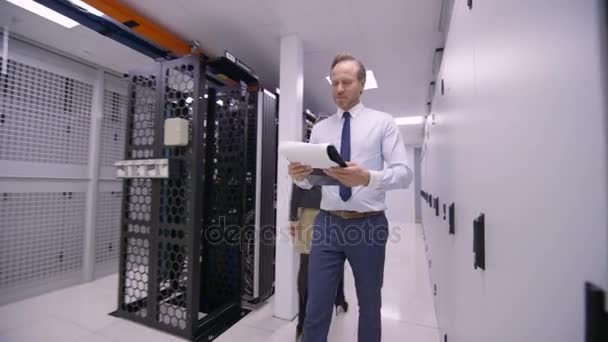 Data Administrator Walking Rows Server Racks Checking Machines — Stock Video