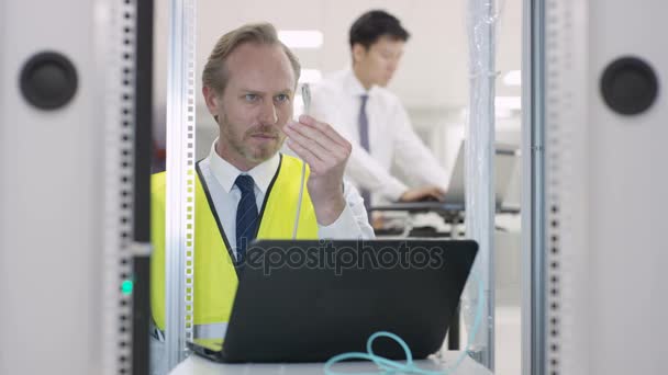 Technical Engineer Carrying Out Checking Data Center Server Room Colleagues — Stock Video