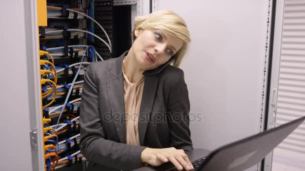 Computer Engineer Working Laptop Talking Phone Checking Servers Data Center — Stock Video