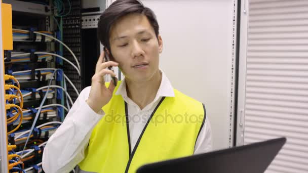 Computer Engineer Working Laptop Talking Phone Checking Servers Data Center — Stock Video