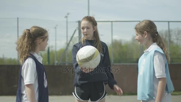 Young School Netball Team Playing Match Outdoor Court — стоковое видео