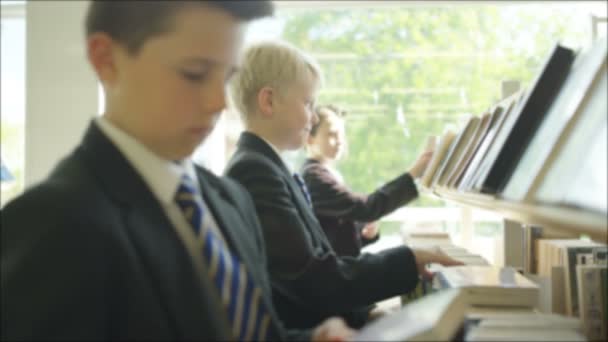 Young Students Browsing Books School Library — стоковое видео