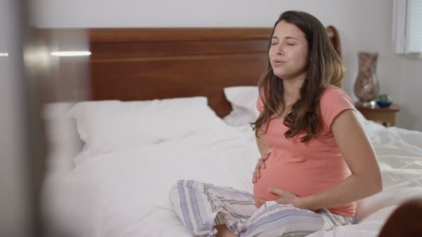 Pregnant Woman Bedroom Making Phone Call Contractions Begin — Stock Video