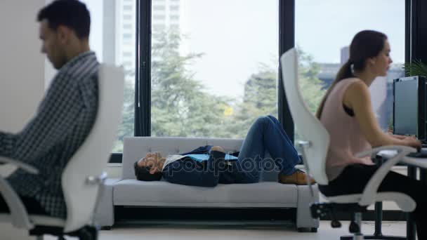 Business Team Working Modern Office Focus Man Sleeping Couch — Stock Video
