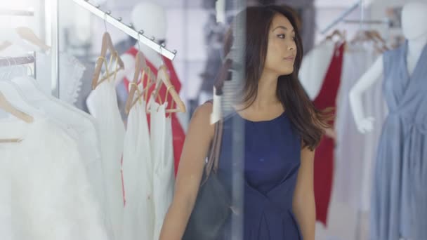 美しい女性客のファッショナブルなブティックの衣料品店でのショッピング — ストック動画