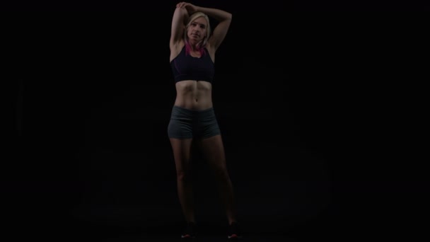 Fitte Junge Frau Mit Athletischem Körperbau Die Sich Vor Schwarzem — Stockvideo
