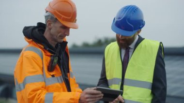 4 k işadamı ve güneş enerjisi tesisi işlemleri tartışırken mühendisi