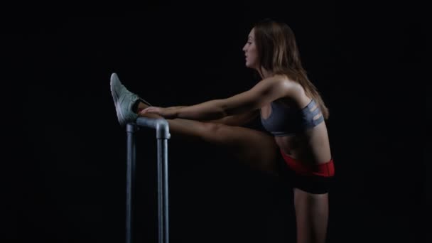 Fit Young Woman Stretching Out Her Leg Muscles Black Background — Stock Video