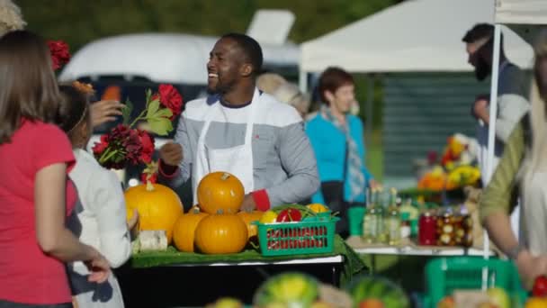 Glad Man Som Säljer Färska Producerar Till Kunder Jordbrukarna Marknaden — Stockvideo