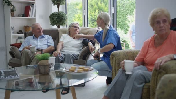 Caring Nurse Checking Elderly Lady Blood Pressure Nursing Home — Stock Video