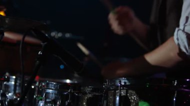 4k Canlı müzik etkinliğinde bir grupla çalan davulcunun ellerine yakın.