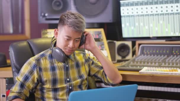 Young Sound Engineer Recording Studio Using Laptop Mixing Desk — Stock Video