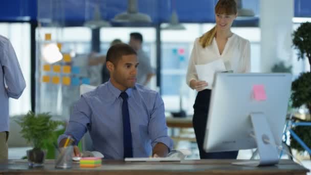 African American Man Working His Desk Modern Office Talking Female — Stock Video