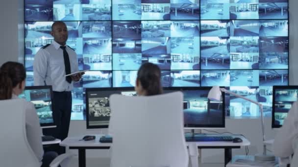 4k Security Officer Communicating With Staff In Observation Control Room