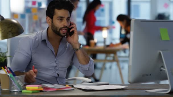 Young Businessman Talking Cell Phone His Desk Colleagues Working Background — Stock Video