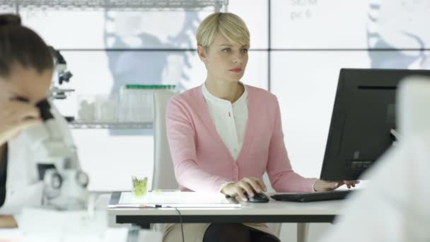 4K Chercheur médical dans le laboratoire analysant l'échantillon et travaillant sur ordinateur 