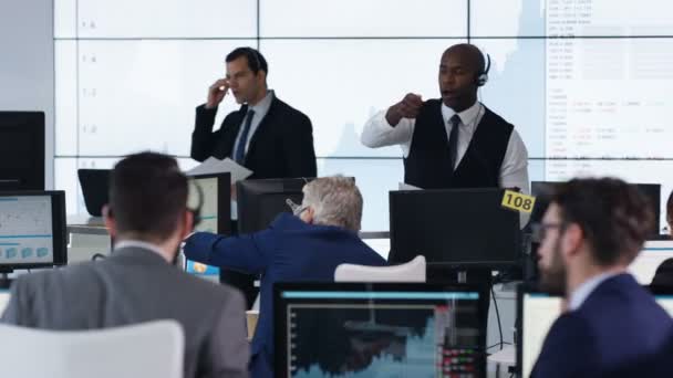 经理在繁忙的证券交易所监督员工和保持他们的积极性 — 图库视频影像