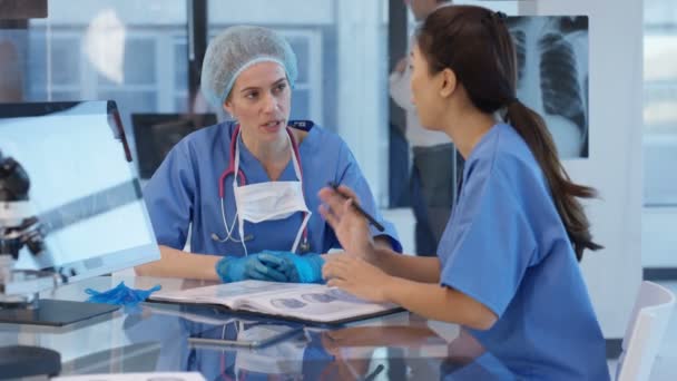 Hospital Doctor Prepared Surgery Discussing Patient Notes Colleague — Stock Video