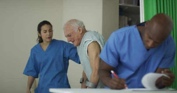 Caring Medical Workers Hospital Assisting Elderly Man Crutches — Stock Video