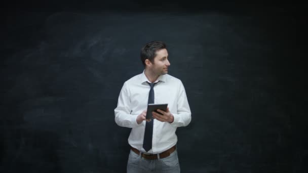 Smiling Businessman Using Tablet Looking Side Chalkboard — Stock Video