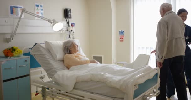 陽気な年配のカップル 男は病院で彼の妻を訪問 — ストック動画