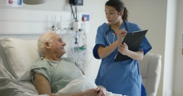 Cuidador Médico Hospital Hablando Con Anciano Lado Cama — Vídeos de Stock