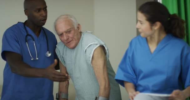 Caring Medical Workers Hospital Assisting Elderly Man Crutches — Stock Video