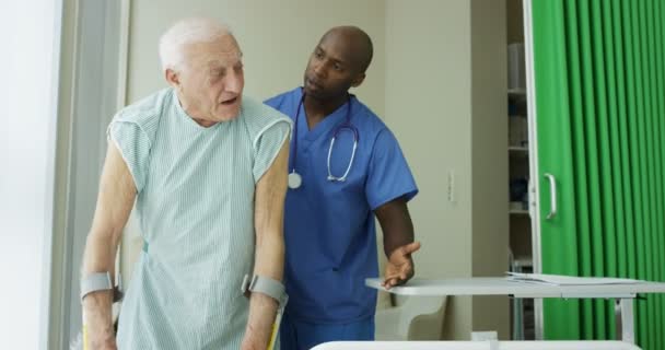 Caring Medical Worker Hospital Assisting Elderly Man Private Room — Stock Video