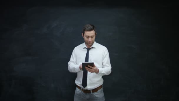 Smiling Businessman Using Tablet Looking Side Chalkboard — Stock Video