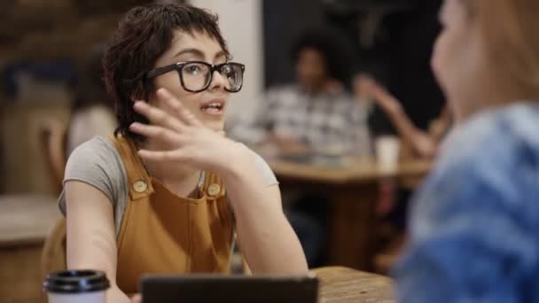 4K快乐的年轻朋友在城市咖啡店聊天和使用技术 — 图库视频影像