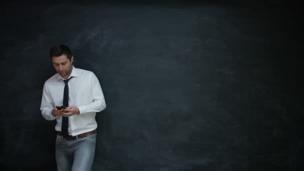 Smiling Businessman Using Smartphone Looking Side Chalkboard — Stock Video