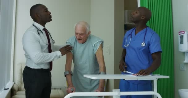 Caring Medical Workers Hospital Assisting Elderly Man Private Room — Stock Video