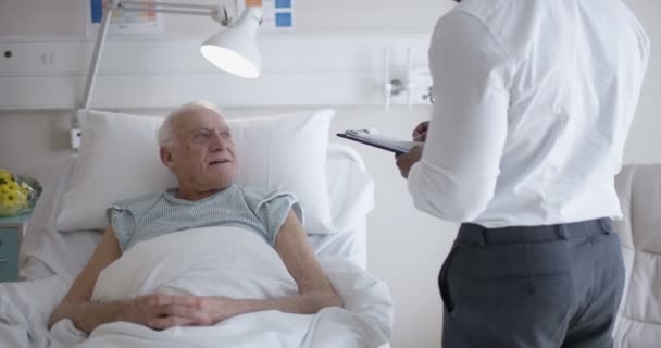 Friendly Doctor Talking Elderly Patient His Bedside — Stock Video