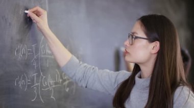 yazı tahtası üzerinde matematiksel Denklem yazma 4 k genç akıllı üniversite öğrencisi