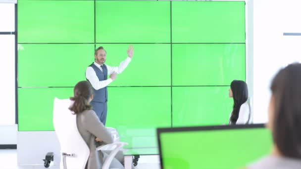 会議では 緑色の画面のビデオ壁と対話する男で ビジネス チーム — ストック動画
