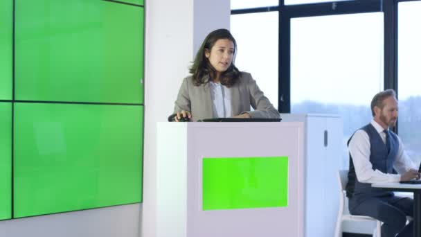 Young Businesswoman Giving Presentation Interacting Green Screen Video Wall — Stock Video